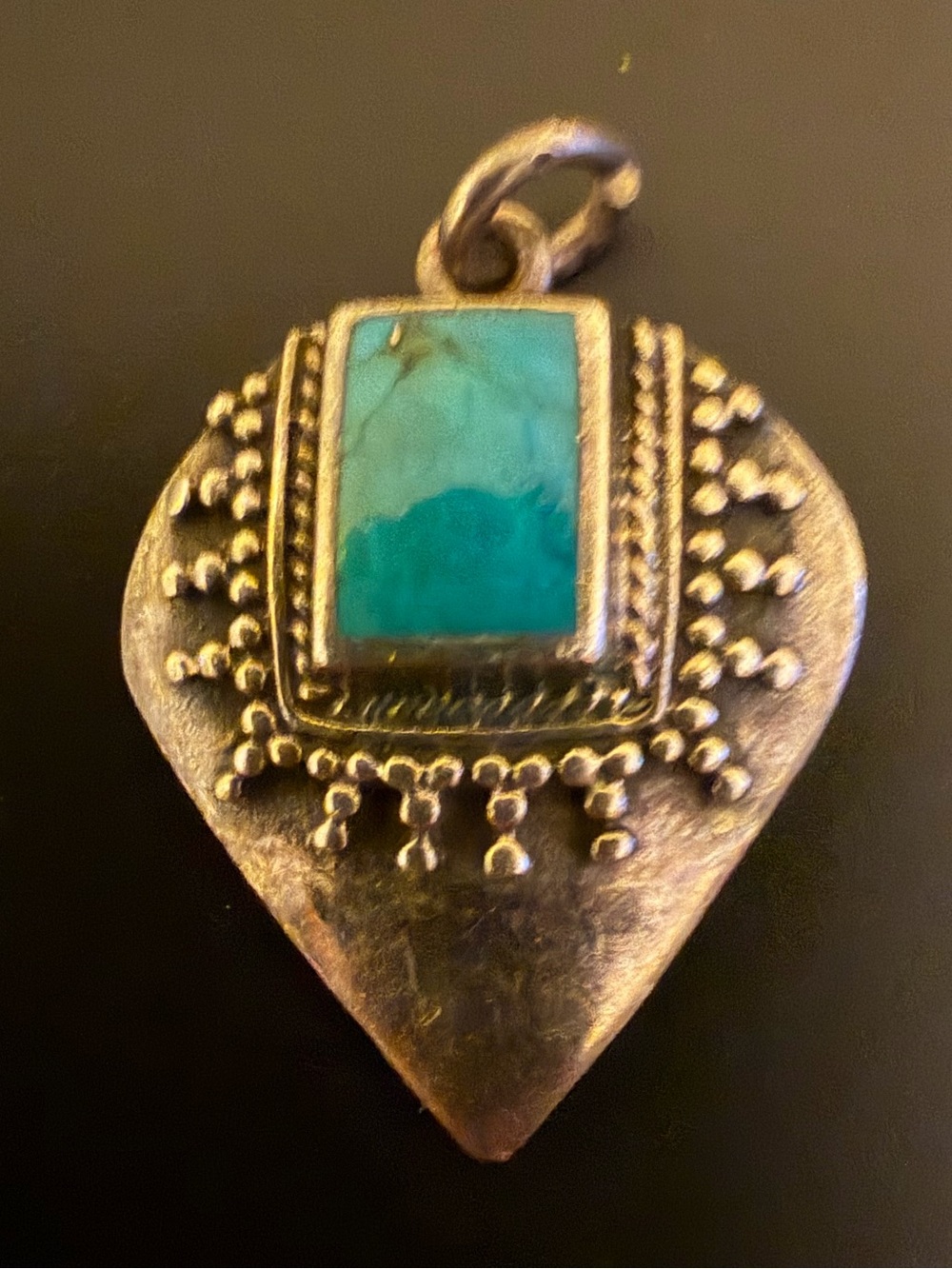925 silver pendant in a teardrop shape with turquoise square surrounded silver